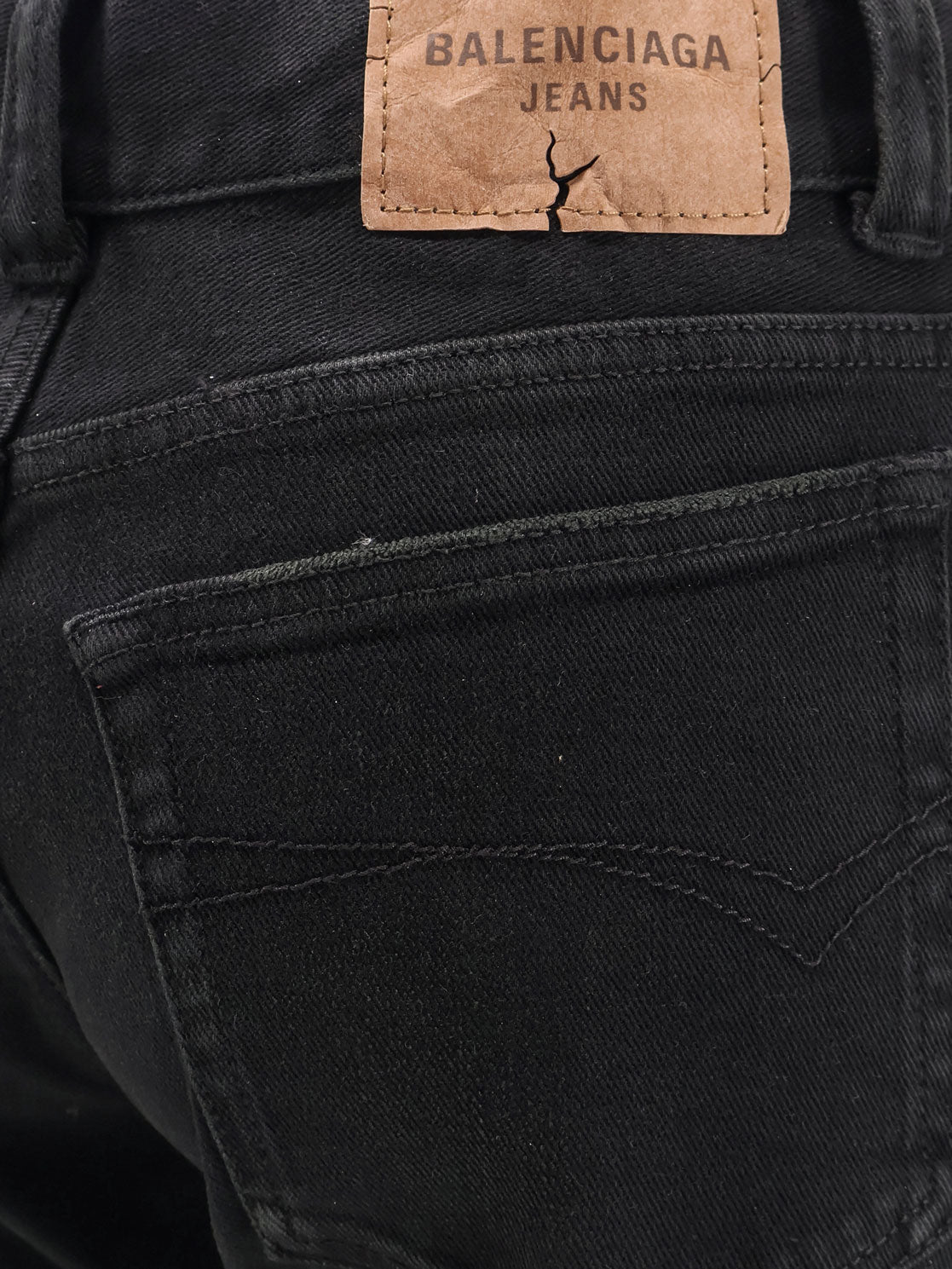 Denim trousers with frayed edges