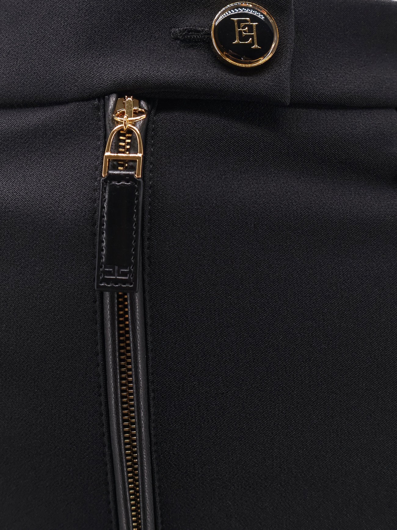 Trousers with logoed button