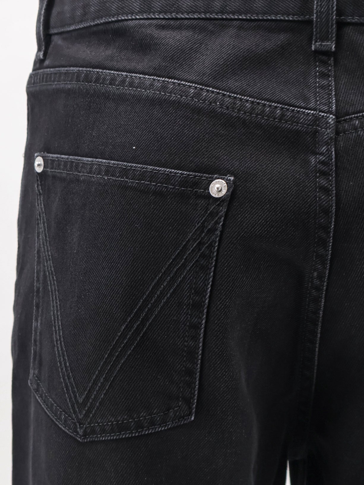 Black denim trousers with back leather patch