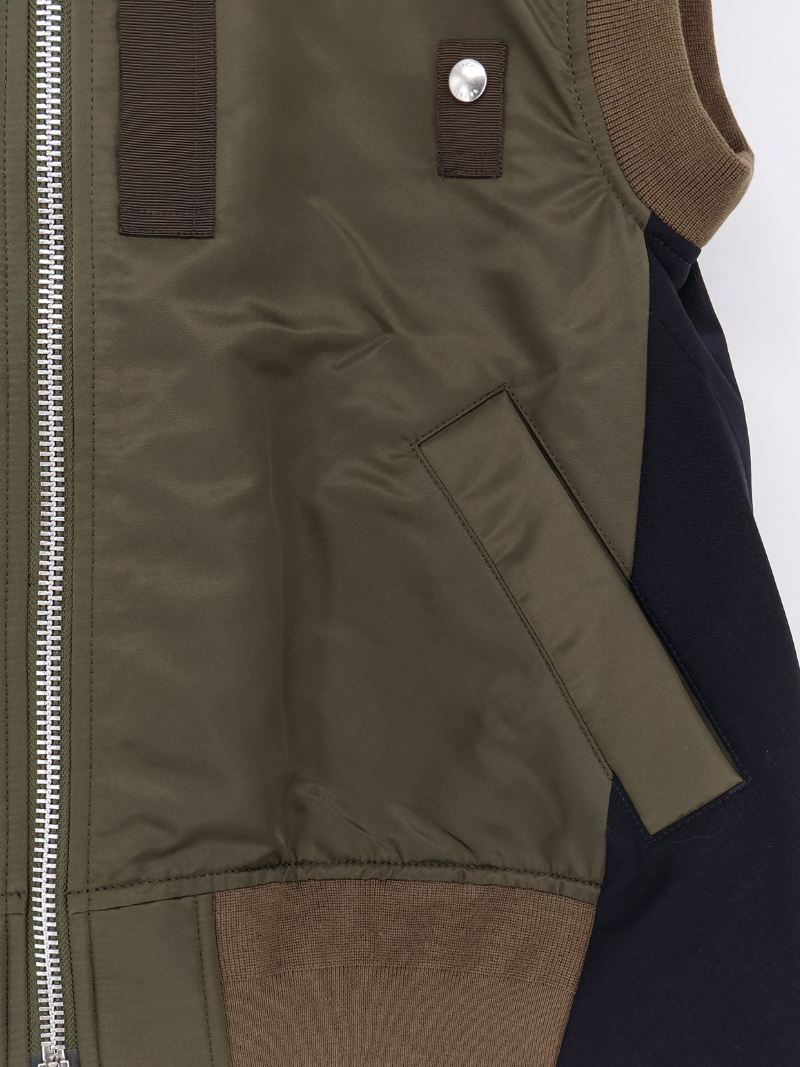 Nylon jacket with fabric insert on the back