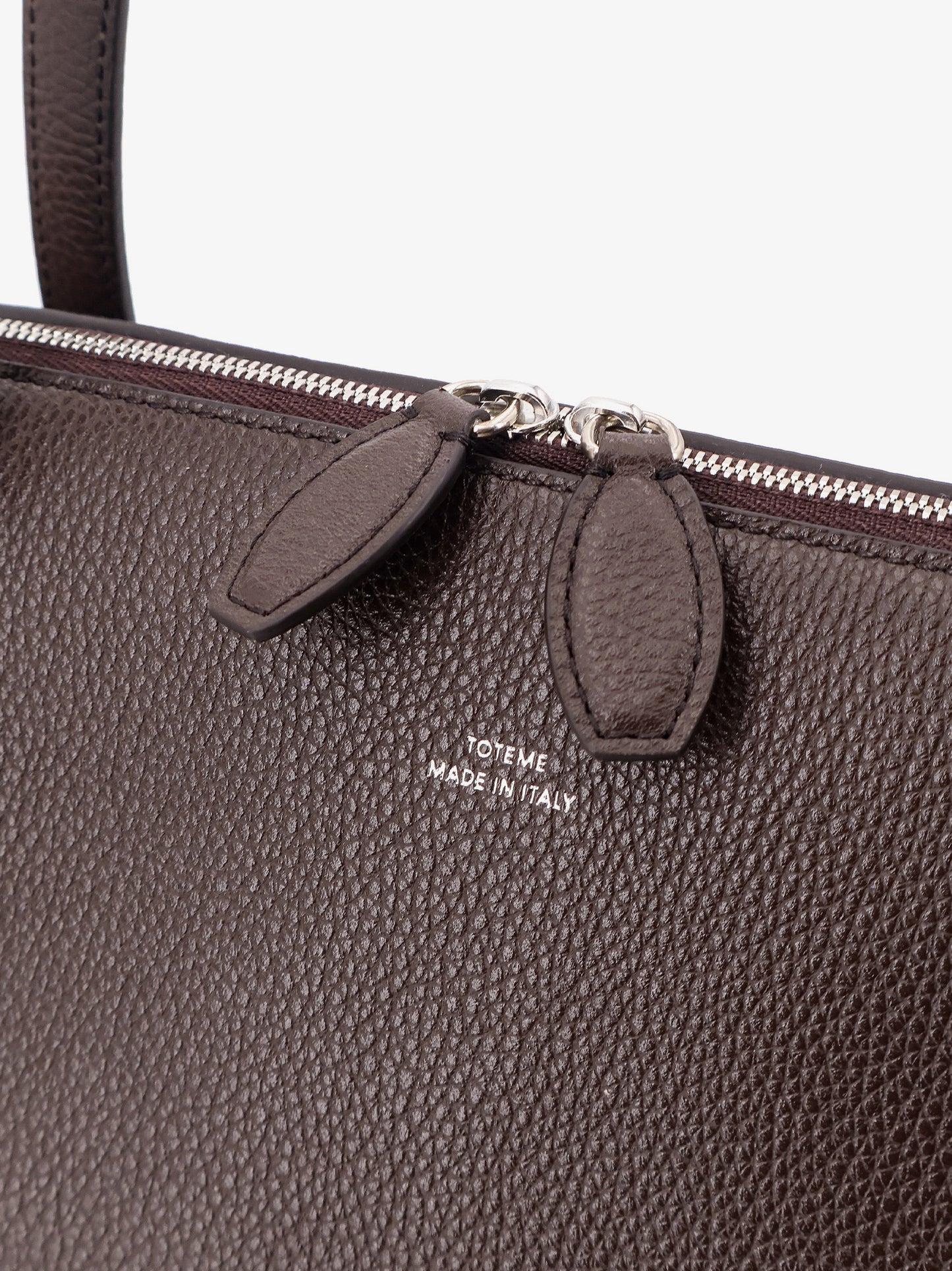 Suede handbag with engraved logo on the front