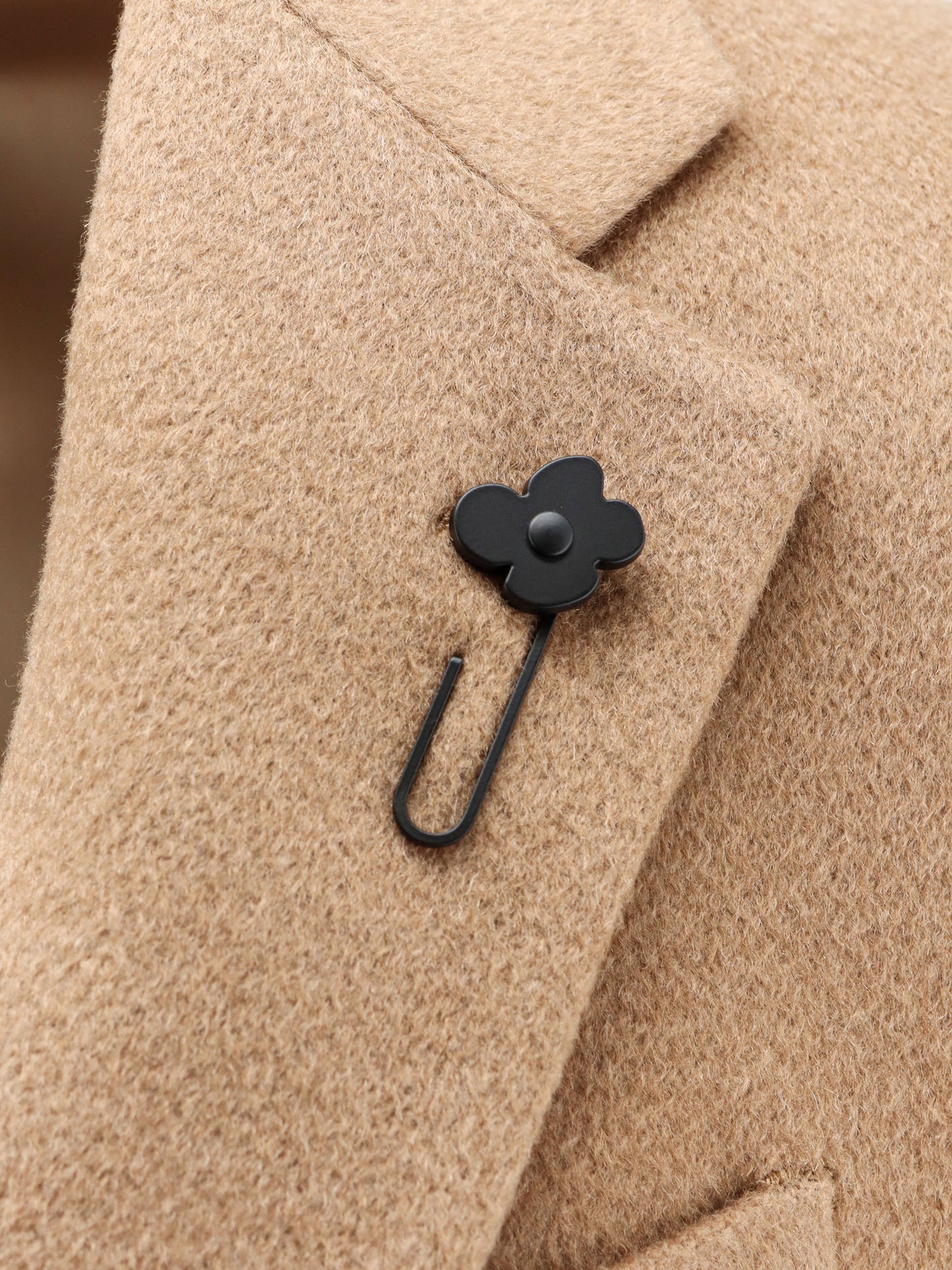 Camel hair coat with iconic brooch