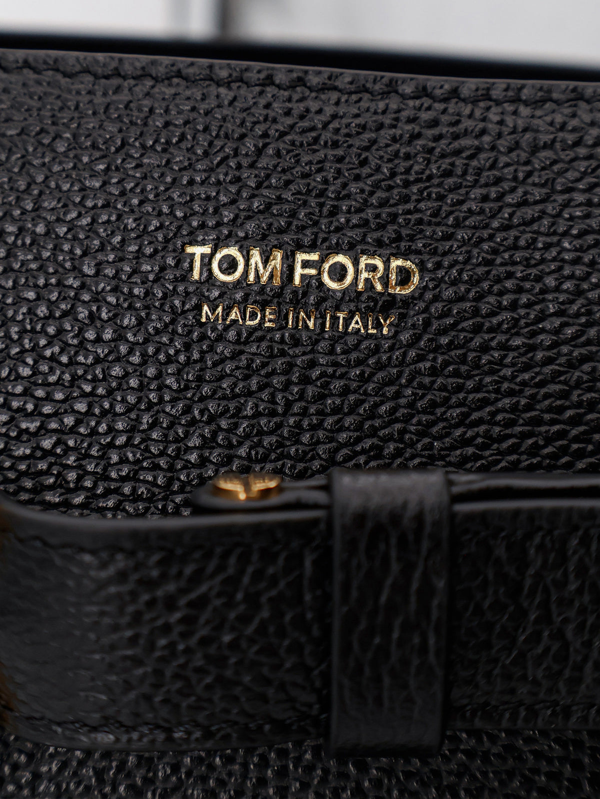 Leather shoulder bag with engraved logo on the front