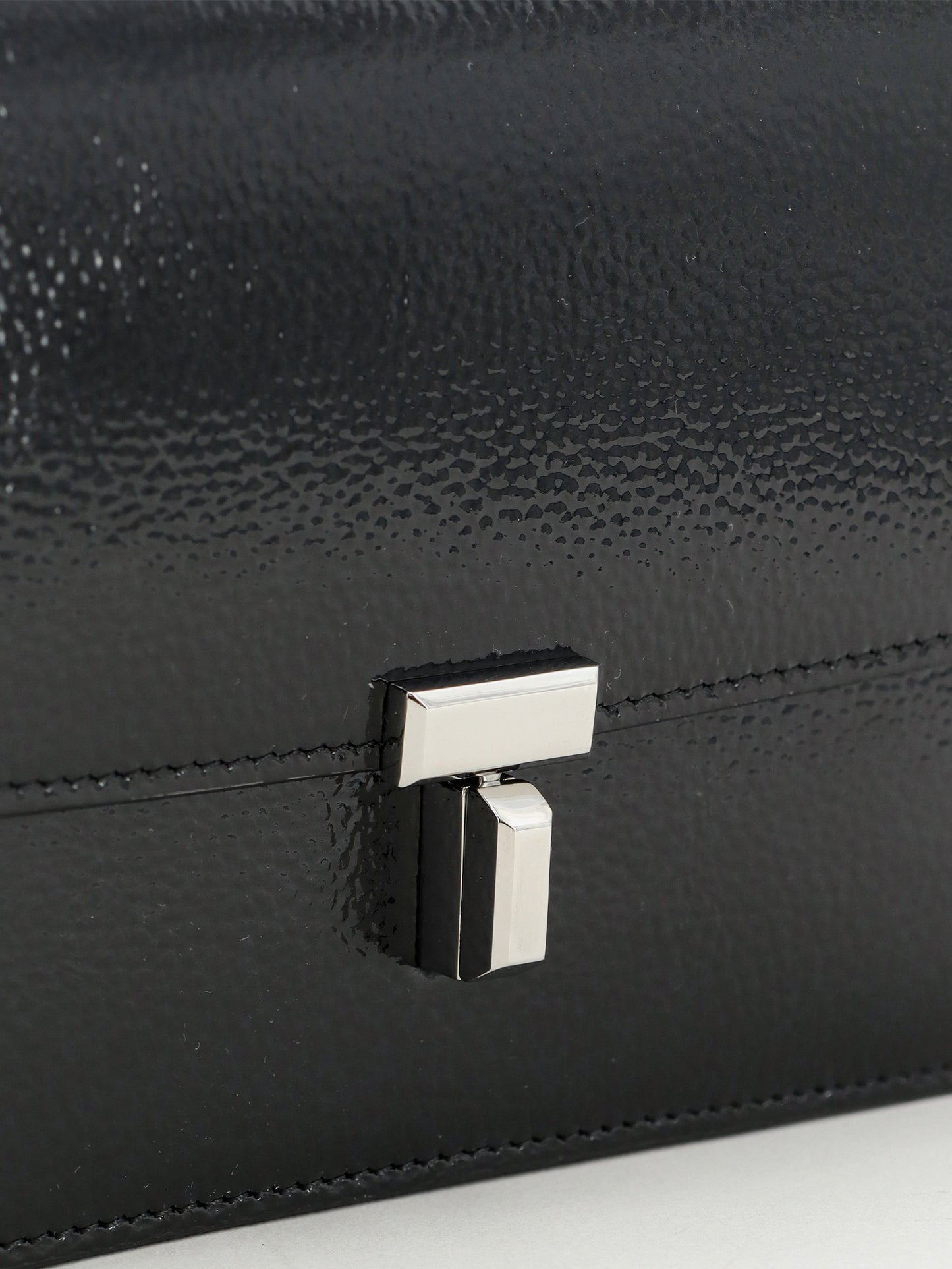 Patent T-Lock crossbody bag