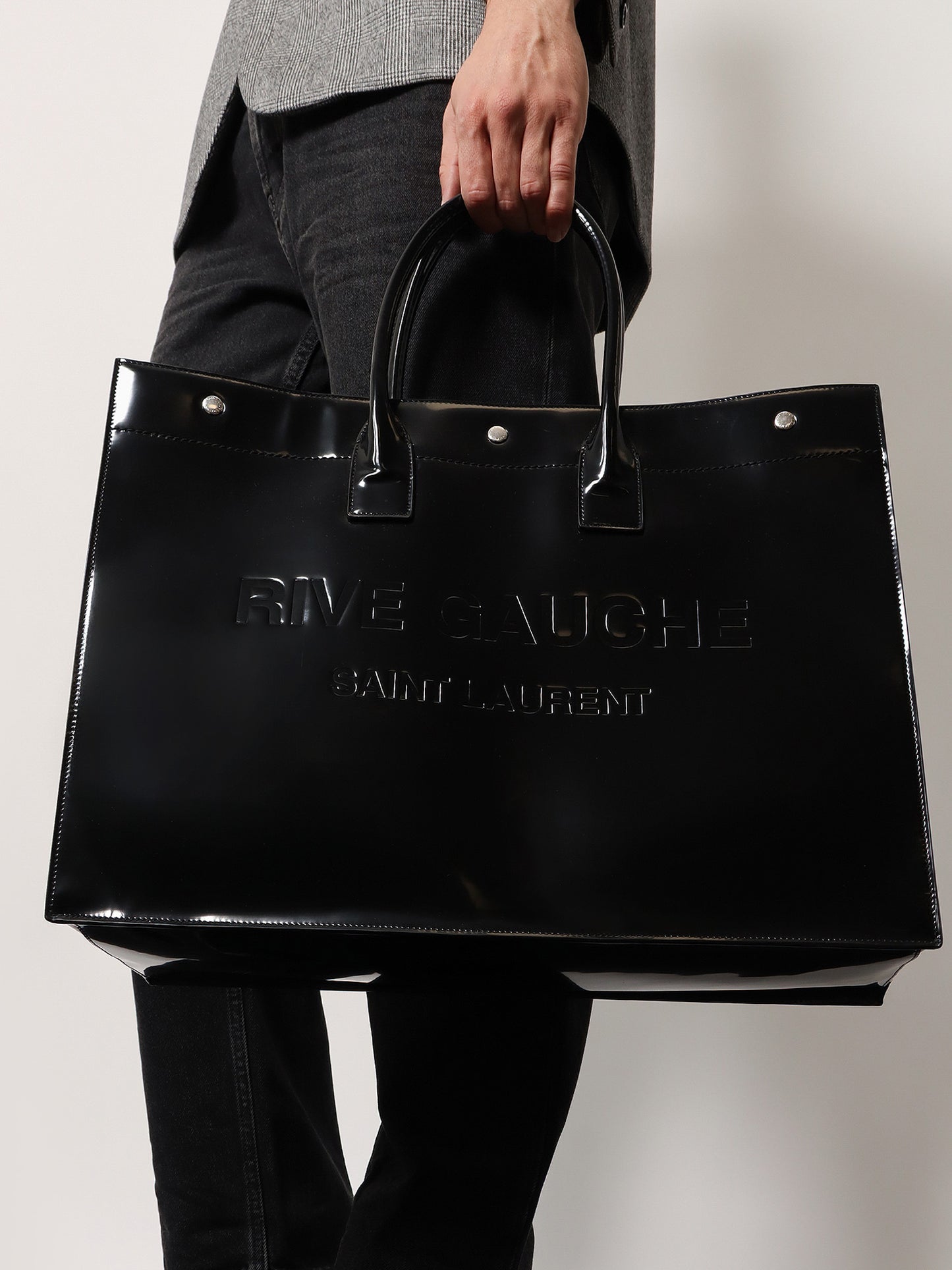 Patent leather handbag with embossed logo