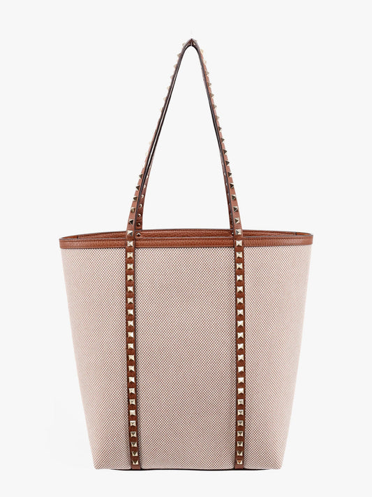 Leather and canvas shoulder bag with iconic studs