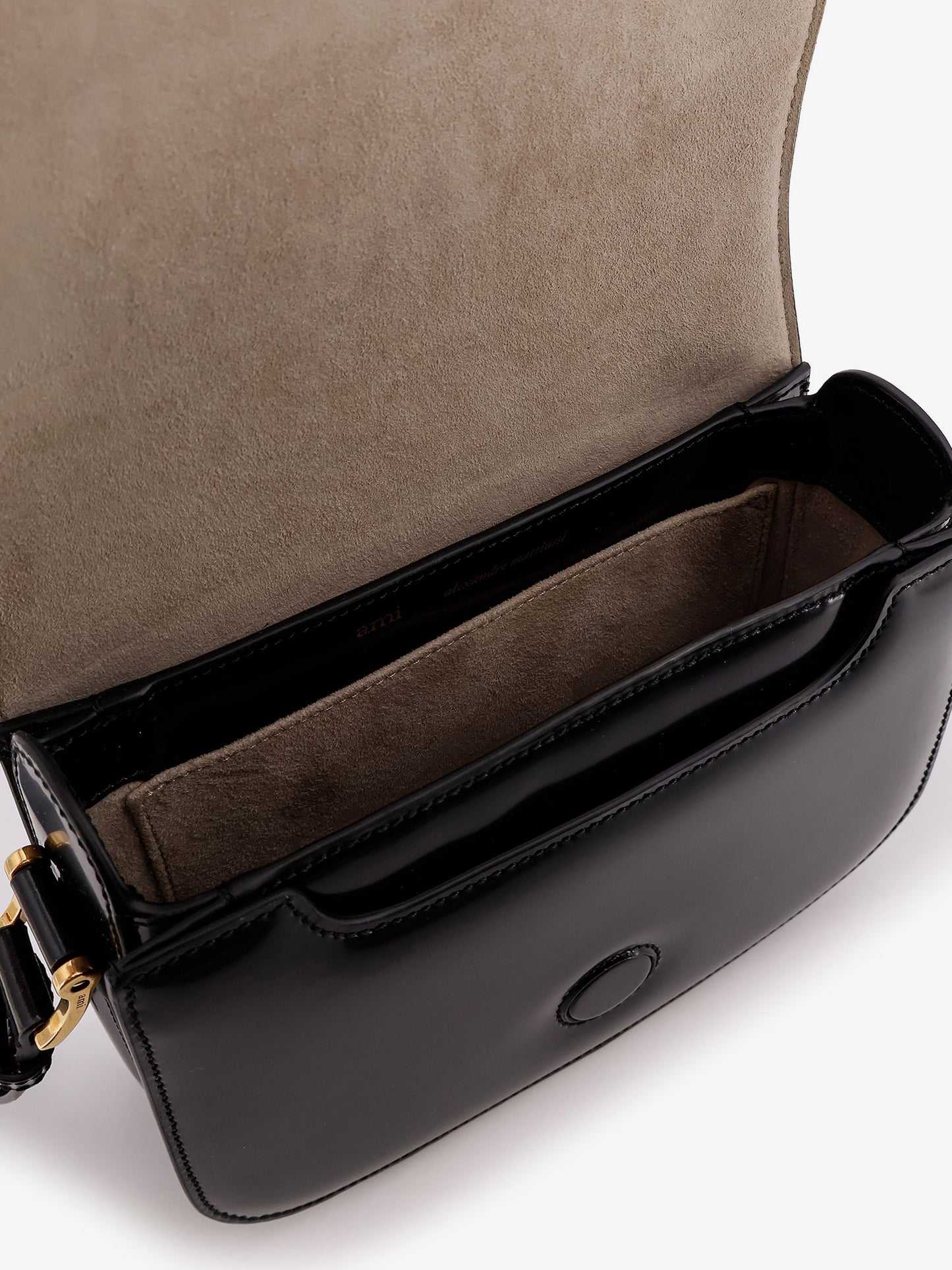 Leather shoulder bag with metal logo on the front