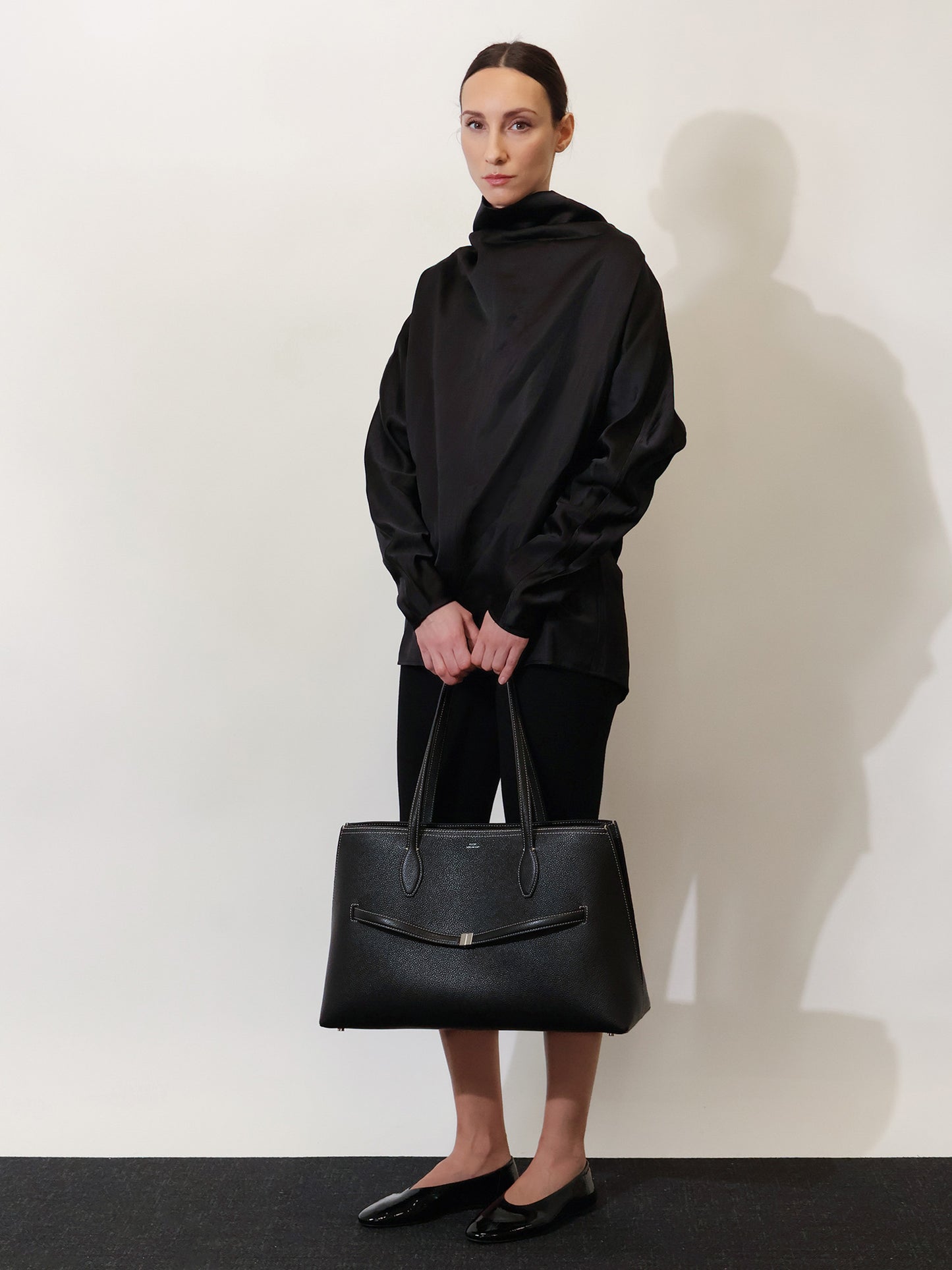 Leather shoulder bag with lettering logo on the front