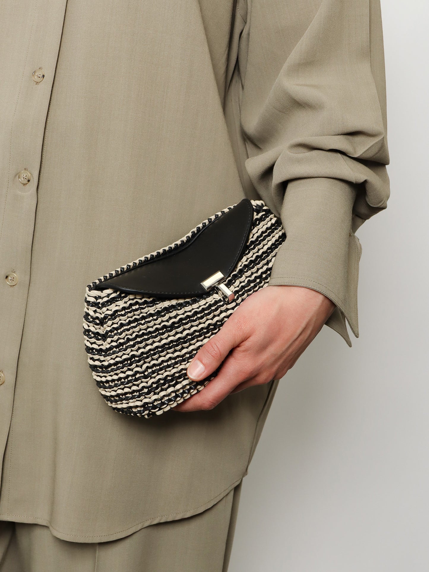 Mini T-lock clutch in leather with woven pattern