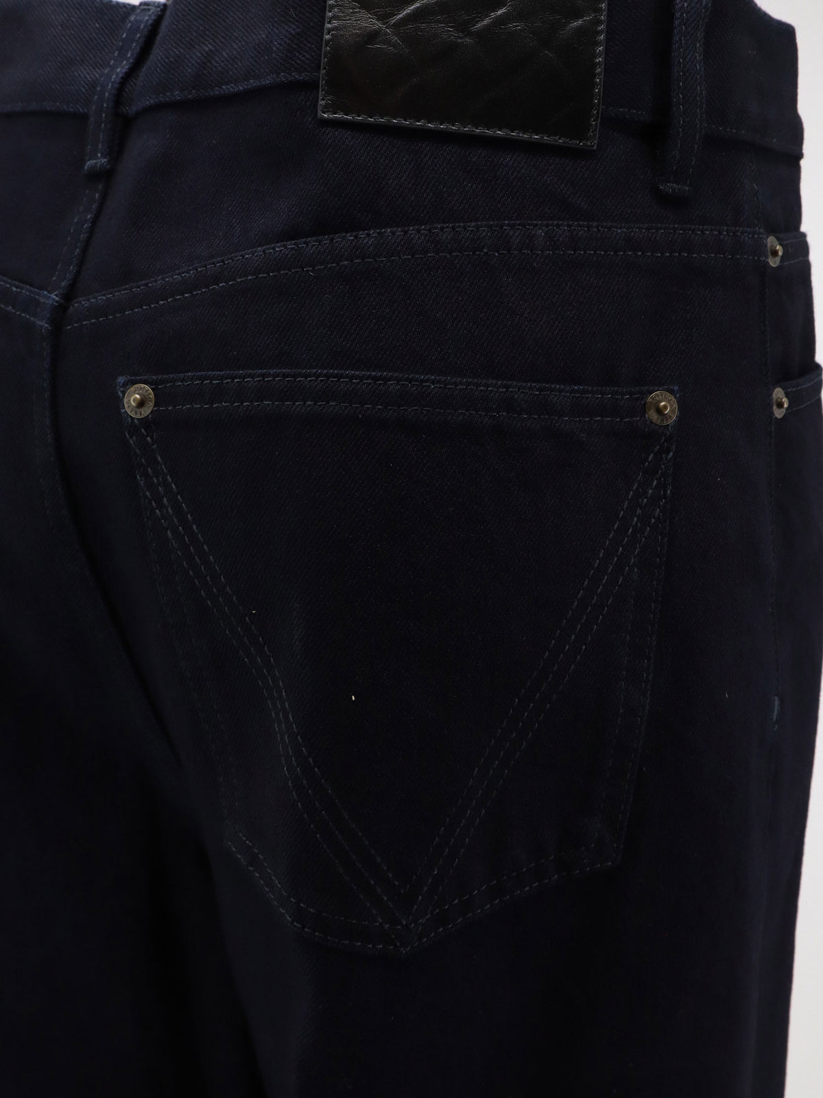 Jeans with leather patch with embossed Intrecciato motif