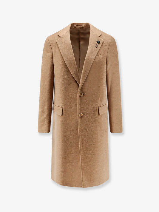 Camel hair coat with iconic brooch