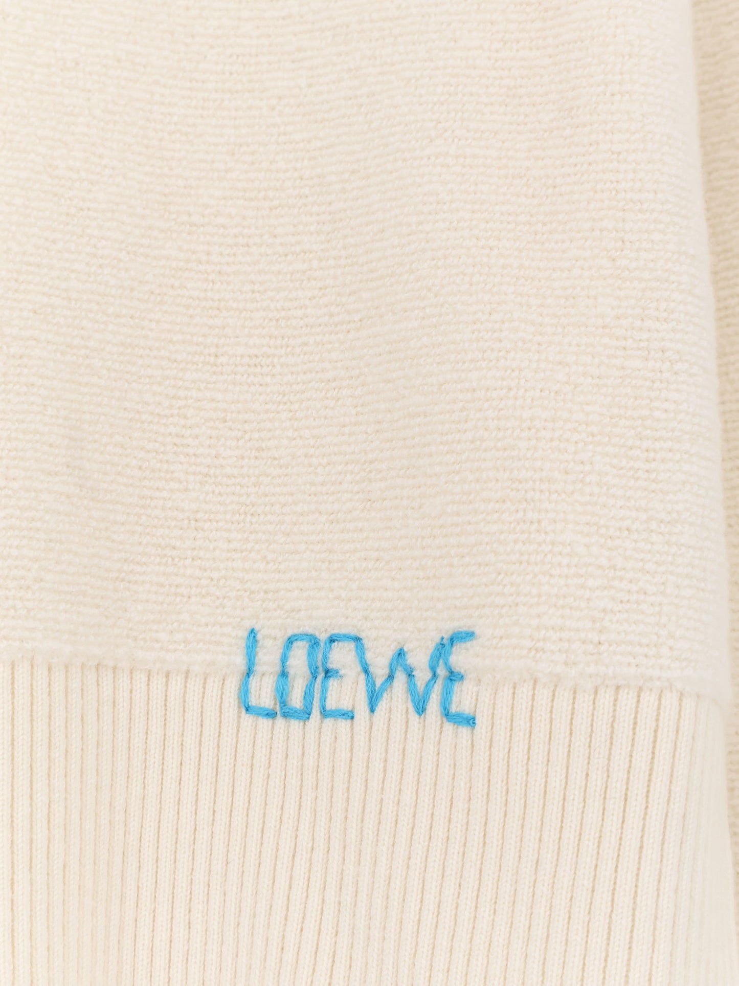 Wool sweater with contrasting embroidered logo on the bottom
