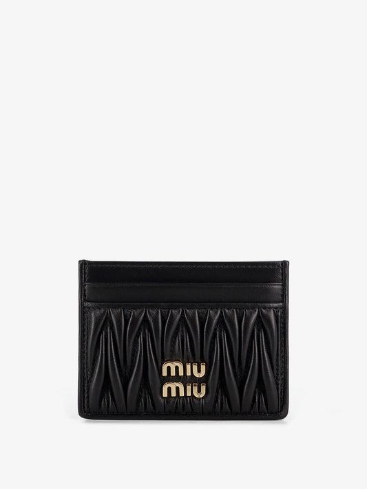 Quilted leather card holder with metal lettering logo